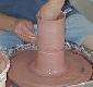 Forming or "throwing" a pot on the potter's wheel